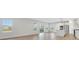 Open living room and kitchen with hardwood floors and lots of natural light at 328 Meuse Ln, Locust Grove, GA 30248