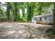 Large concrete backyard with a deck and trees at 1574 Mayflower St, Atlanta, GA 30311