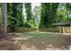 Fenced backyard with a fire pit and lush greenery at 1574 Mayflower St, Atlanta, GA 30311