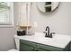Bathroom with green vanity, updated sink, and decorative wall hanging at 1574 Mayflower St, Atlanta, GA 30311