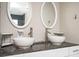 Modern bathroom with double sinks, granite countertops, and oval mirrors at 1574 Mayflower St, Atlanta, GA 30311