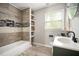 Updated bathroom with tile shower, a new vanity, and shelving at 1574 Mayflower St, Atlanta, GA 30311