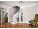 Elegant entryway with hardwood floors, a staircase, and stylish armchairs at 1574 Mayflower St, Atlanta, GA 30311