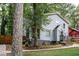 Two story light gray house with dark gray accents and landscaping at 1574 Mayflower St, Atlanta, GA 30311