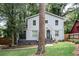 Two story light gray house with dark gray accents and landscaping at 1574 Mayflower St, Atlanta, GA 30311