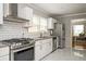 Modern kitchen with white cabinets and granite countertops at 1574 Mayflower St, Atlanta, GA 30311