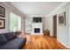 Living room with hardwood floors, fireplace, and access to outdoor patio at 1574 Mayflower St, Atlanta, GA 30311
