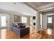Spacious living room with hardwood floors, fireplace, and large sectional sofa at 1574 Mayflower St, Atlanta, GA 30311