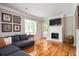 Bright living room featuring hardwood floors, fireplace, and comfortable seating at 1574 Mayflower St, Atlanta, GA 30311