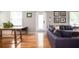 Living room with hardwood floors, sectional sofa, and wooden coffee table at 1574 Mayflower St, Atlanta, GA 30311