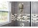 Updated shower with dual shower heads and gray tile at 1574 Mayflower St, Atlanta, GA 30311