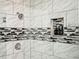 Updated shower with stylish tile and built-in shelves at 1574 Mayflower St, Atlanta, GA 30311