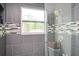 Large shower with gray tile, glass enclosure, and a window at 1574 Mayflower St, Atlanta, GA 30311