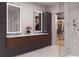 Modern bathroom with dual vanities, backlit mirrors, walk-in shower, and adjacent walk-in closet at 318 Sandy Springs Cir # 260, Sandy Springs, GA 30328