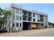 Multi-Gathering gray building featuring large windows, a modern design, and street access at 318 Sandy Springs Cir # 260, Sandy Springs, GA 30328