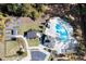 Aerial view of a community pool, garden, and parking area amidst lush greenery at 418 Townly, Alpharetta, GA 30009