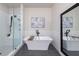 Luxurious bathroom featuring a soaking tub and a glass-enclosed shower at 418 Townly, Alpharetta, GA 30009