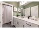 Lovely bathroom showcasing a white vanity, framed art, and modern black hardware at 418 Townly, Alpharetta, GA 30009