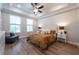 Bright bedroom with tray ceiling, a ceiling fan, and lots of natural light from large windows at 418 Townly, Alpharetta, GA 30009