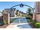 Brick entrance arch to the community with townhomes visible beyond at 418 Townly, Alpharetta, GA 30009