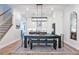 Open-concept dining area features a dark wood table, bench seating, and is adjacent to the modern kitchen at 418 Townly, Alpharetta, GA 30009