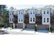 Three-story townhomes featuring attached garages and private balconies at 418 Townly, Alpharetta, GA 30009