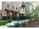Attractive townhome with brick and stone accents, a fenced yard, and a covered patio at 418 Townly, Alpharetta, GA 30009