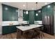 Stylish kitchen features green cabinets, a center island, and stainless steel appliances at 418 Townly, Alpharetta, GA 30009