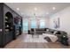 Elegant living room featuring a fireplace, custom shelving, and ample seating at 418 Townly, Alpharetta, GA 30009