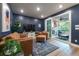 Stylish living room with an open sliding glass door to an outdoor living space with a fireplace at 418 Townly, Alpharetta, GA 30009