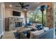Covered patio with stone fireplace, outdoor seating, and ceiling fan at 418 Townly, Alpharetta, GA 30009