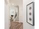 Hallway leading to stairs, with a framed art piece on the wall at 1621 Aiden Way # 57, Conyers, GA 30013