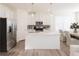 Modern kitchen with white cabinets, stainless steel appliances, and a center island at 1621 Aiden Way # 57, Conyers, GA 30013