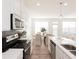 Stylish kitchen with stainless steel appliances, white countertops, and dining area in background at 1621 Aiden Way # 57, Conyers, GA 30013