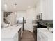 Bright kitchen featuring white cabinetry, stainless steel appliances, and an open layout at 1621 Aiden Way # 57, Conyers, GA 30013
