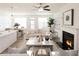Cozy living room with a modern fireplace, neutral furniture, and open access to the kitchen at 1621 Aiden Way # 57, Conyers, GA 30013