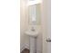 Small, updated powder room with pedestal sink and mirrored medicine cabinet at 1621 Aiden Way # 57, Conyers, GA 30013
