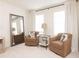 Sitting area in bedroom with two comfy armchairs and a large mirror at 1621 Aiden Way # 57, Conyers, GA 30013