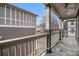 Covered deck featuring stone flooring, white wood railings, and a ceiling fan at 692 Rose Palm Ln, Atlanta, GA 30315