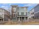 Charming green two-story home featuring a picket fence and well-maintained landscaping at 692 Rose Palm Ln, Atlanta, GA 30315