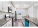 Modern kitchen featuring granite countertops, stainless steel appliances, and white cabinetry at 692 Rose Palm Ln, Atlanta, GA 30315
