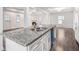 Elegant kitchen featuring a large granite-topped island, stainless steel appliances, and hardwood floors at 692 Rose Palm Ln, Atlanta, GA 30315