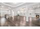 Bright open-concept living area featuring a fireplace, dark hardwood floors, and adjacent kitchen at 692 Rose Palm Ln, Atlanta, GA 30315