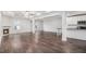 Open-concept living area with dark hardwood floors, fireplace, and seamless flow to the kitchen at 692 Rose Palm Ln, Atlanta, GA 30315