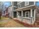 Inviting porch featuring white pillars and trim, complemented by landscaped flower beds at 692 Rose Palm Ln, Atlanta, GA 30315