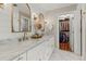 Bright bathroom with double sinks, marble counters, and a walk-in closet at 327 Balaban Cir, Woodstock, GA 30188