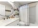Bathroom with a white vanity, a round mirror, and a shower-tub combo at 327 Balaban Cir, Woodstock, GA 30188