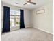 Bedroom with ceiling fan, window, neutral carpet and dark blue curtains at 327 Balaban Cir, Woodstock, GA 30188