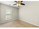 Carpeted bedroom with a ceiling fan and a window with natural light at 327 Balaban Cir, Woodstock, GA 30188