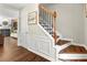 Elegant entryway with wood floors, decorative wainscoting, staircase, and a view of the living room at 327 Balaban Cir, Woodstock, GA 30188